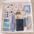 Navy butterfly journal gift box in white box showing embossed mandala wrap journal, boxed blue-and-white pen set, blue retractable pen, blue glitter pen, butterfly sticker sheet, butterfly sticky-note pad, page marker sets, affirmation cards, pocket hug keepsake, dragonfly keychain, lavender correction tape, accessory case, folding utility accessories and blue paperclips