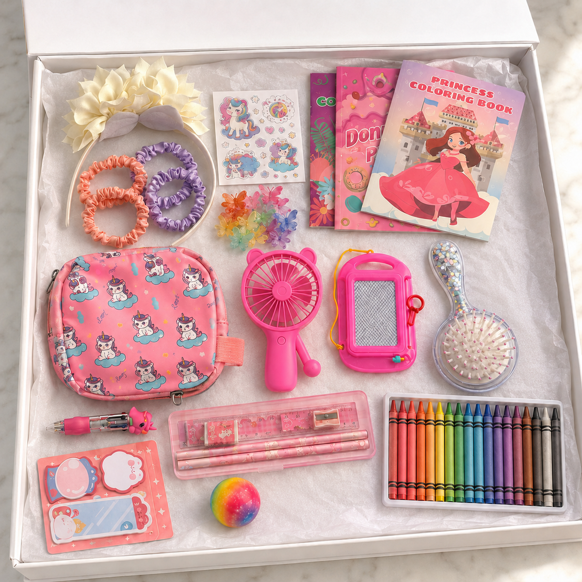 Pink unicorn princess activity gift box in white box showing pink unicorn mini bag, hand fan, princess coloring books, crayons, pink pencil set, magnetic drawing board, unicorn pen, cream floral headband, satin hair ties, butterfly clips, unicorn stickers, glitter hairbrush, sticky notes and sensory ball