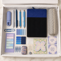 Blue corduroy journal gift box in white box showing black corduroy notebook with royal-blue panel, gingham pencil pouch, blue and silver pens, lavender correction tape, page marker sets, butterfly sticky notes, affirmation cards, pocket hug keepsake, floral accessory case and assorted blue paperclips