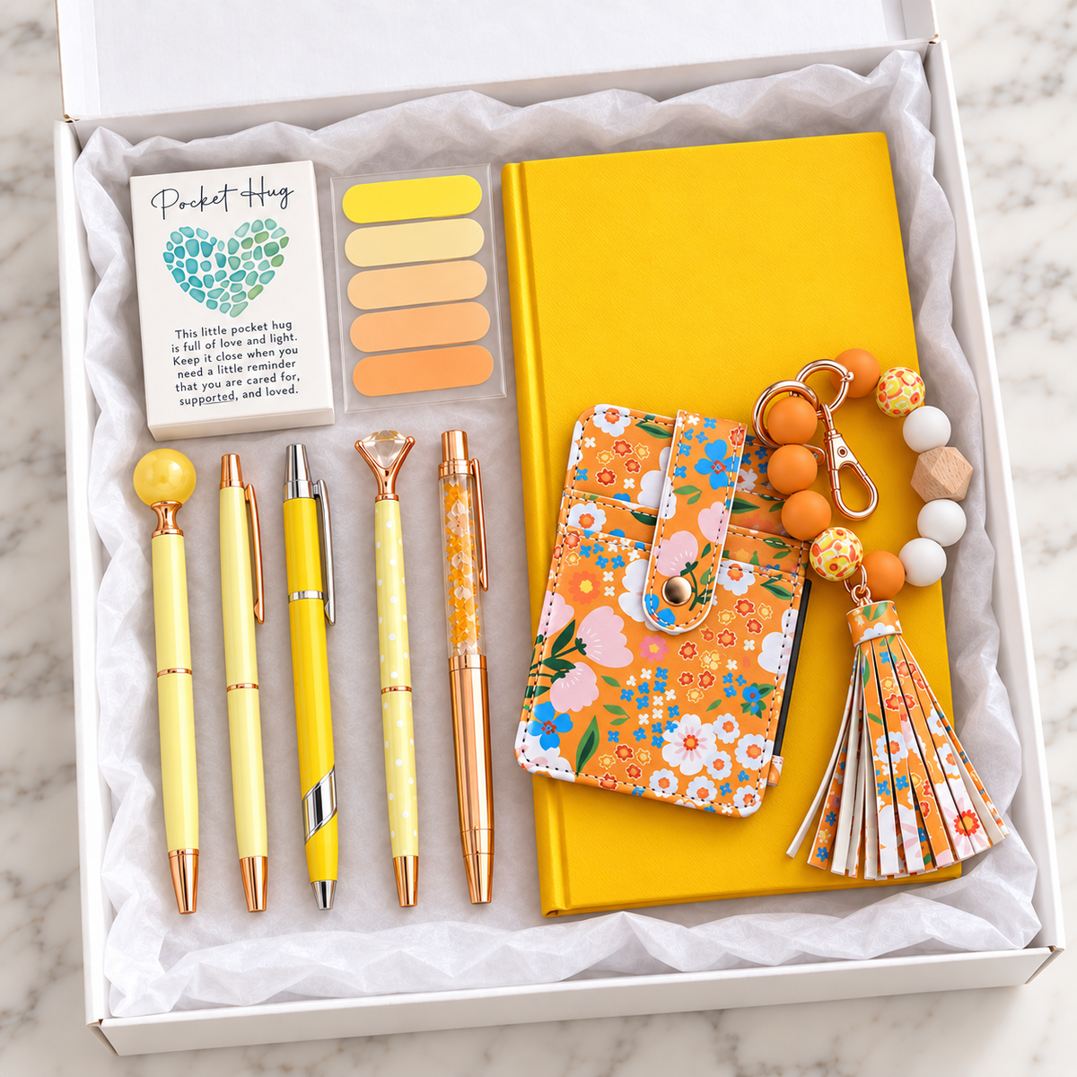 Sunshine Floral Wristlet Wallet Gift Box – yellow hardcover notebook, floral wallet with beaded wristlet keychain, matching tassel, yellow and rose-gold decorative pens, page flags, and pocket hug keepsake arranged in white gift box