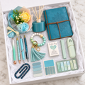 Aqua Serenity Journal Gift Box – teal embossed mandala journal, teal reed diffuser, yellow and aqua rose bouquet, mint beaded wristlet keychain with tassel, four decorative pens, sticky note sets, floral paperclip, and Pocket Hug keepsake arranged in white gift box